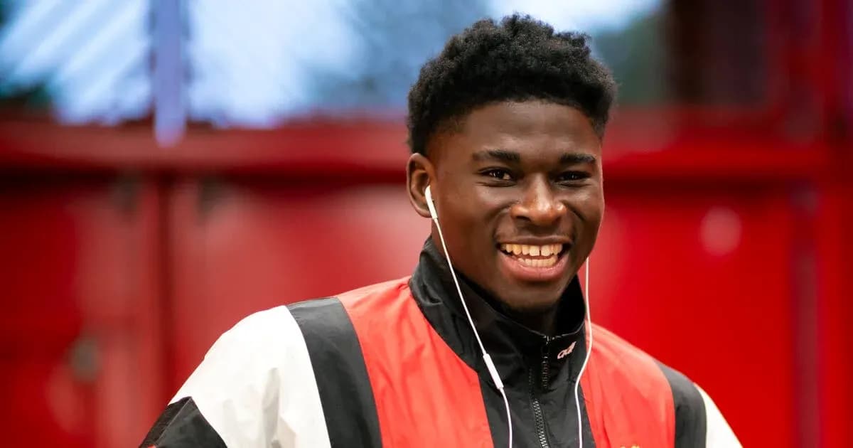 Player smiling while wearing headphones in training facility Player smiling while wearing headphones in training facility