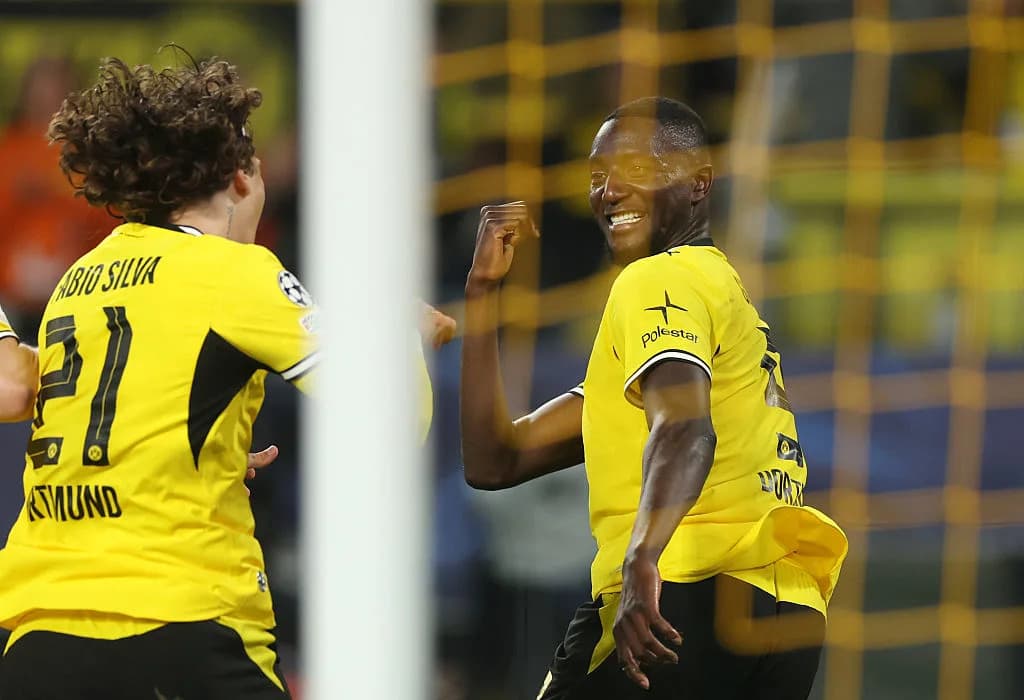 Players celebrating a goal during a match Players celebrating a goal during a match