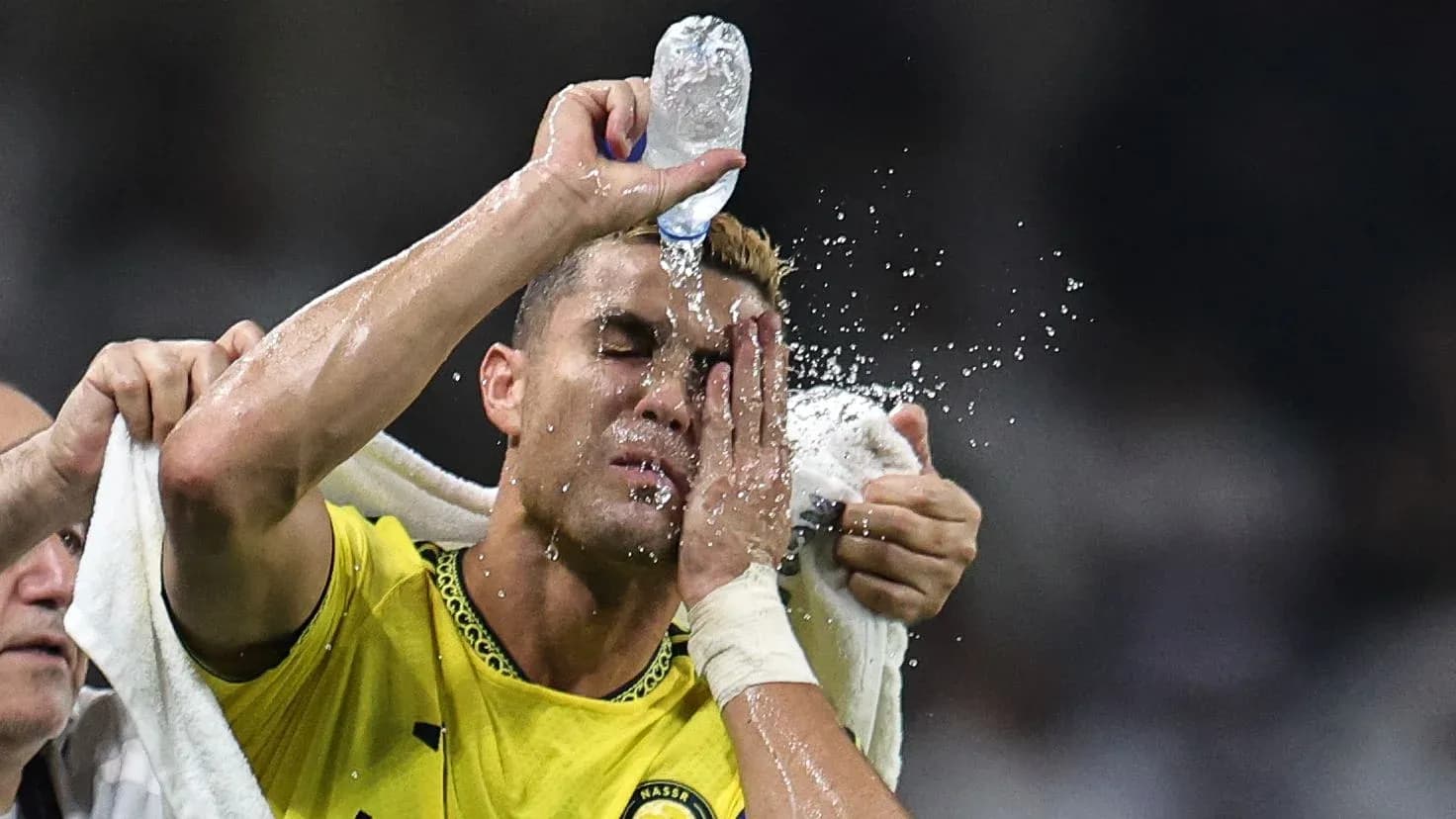 Player cooling off with water during match Player cooling off with water during match