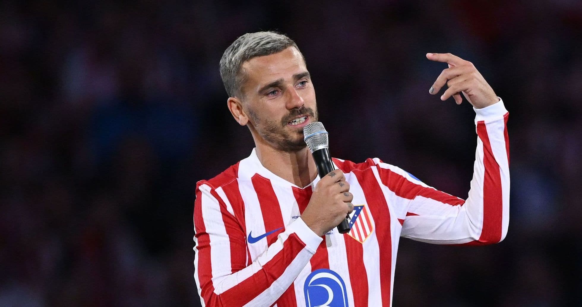 Player speaking into a microphone at event Player speaking into a microphone at event