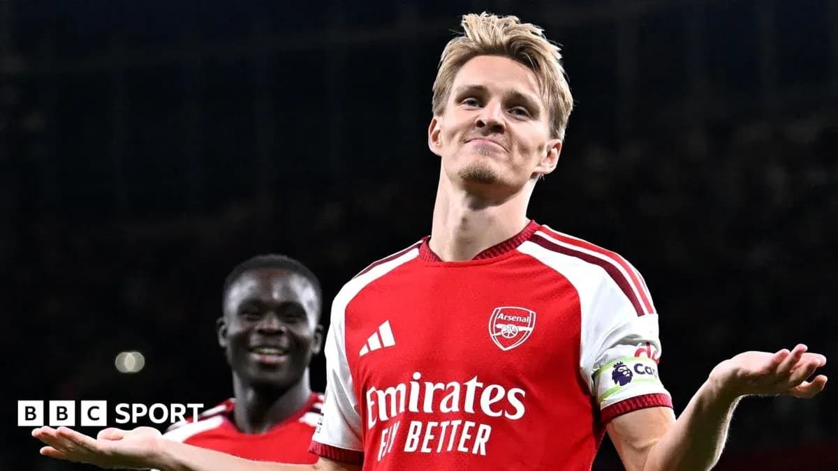 Arsenal player celebrating with teammates after scoring Arsenal player celebrating with teammates after scoring