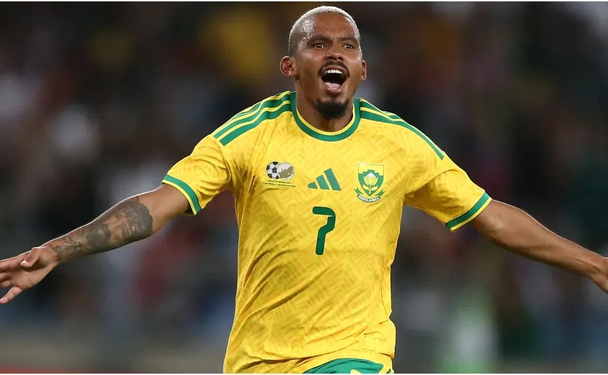 Player celebrating a goal in yellow South Africa jersey Player celebrating a goal in yellow South Africa jersey
