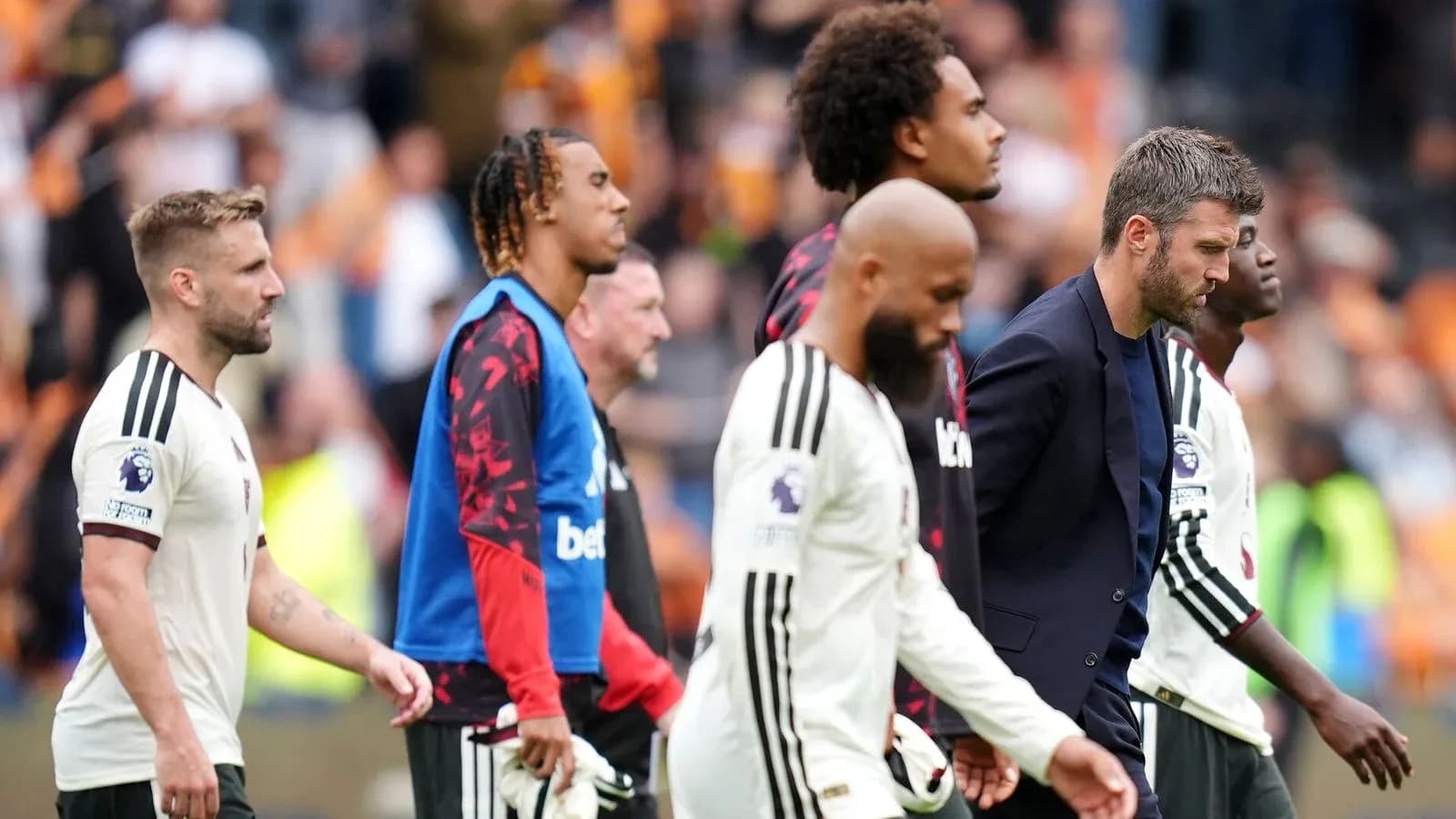 Players and manager walking off the pitch after match Players and manager walking off the pitch after match