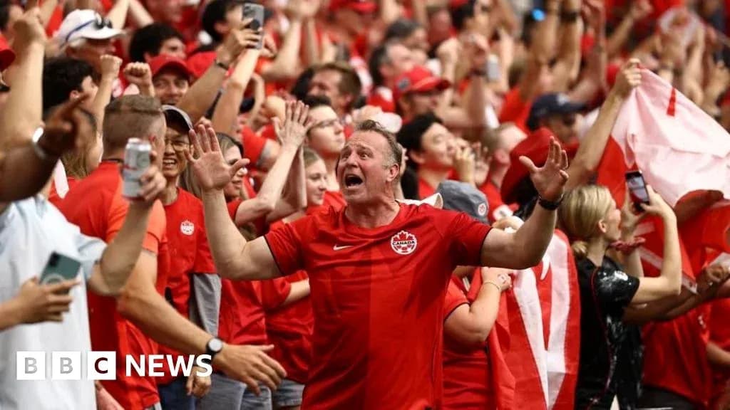 Fans celebrating in red at a sports event Fans celebrating in red at a sports event
