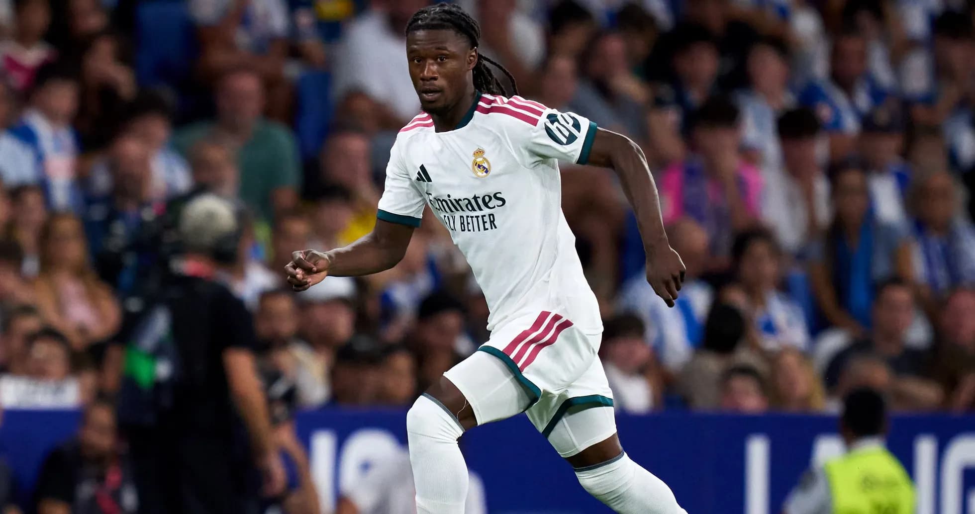 Player in white jersey running during football match Player in white jersey running during football match