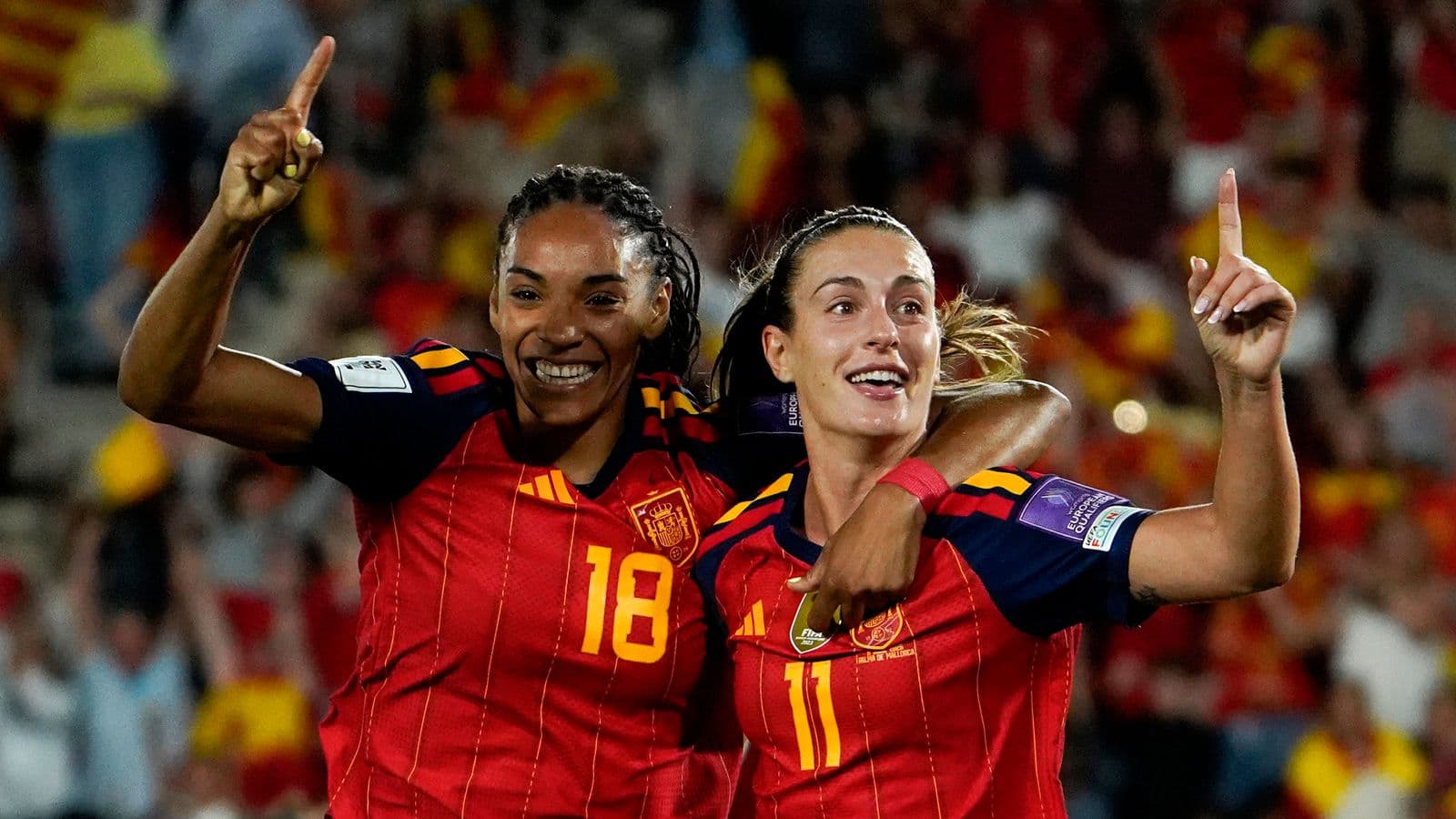 Two Spanish players celebrating a goal together Two Spanish players celebrating a goal together