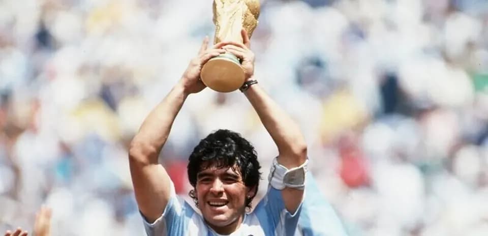 Player celebrating with World Cup trophy raised high Player celebrating with World Cup trophy raised high