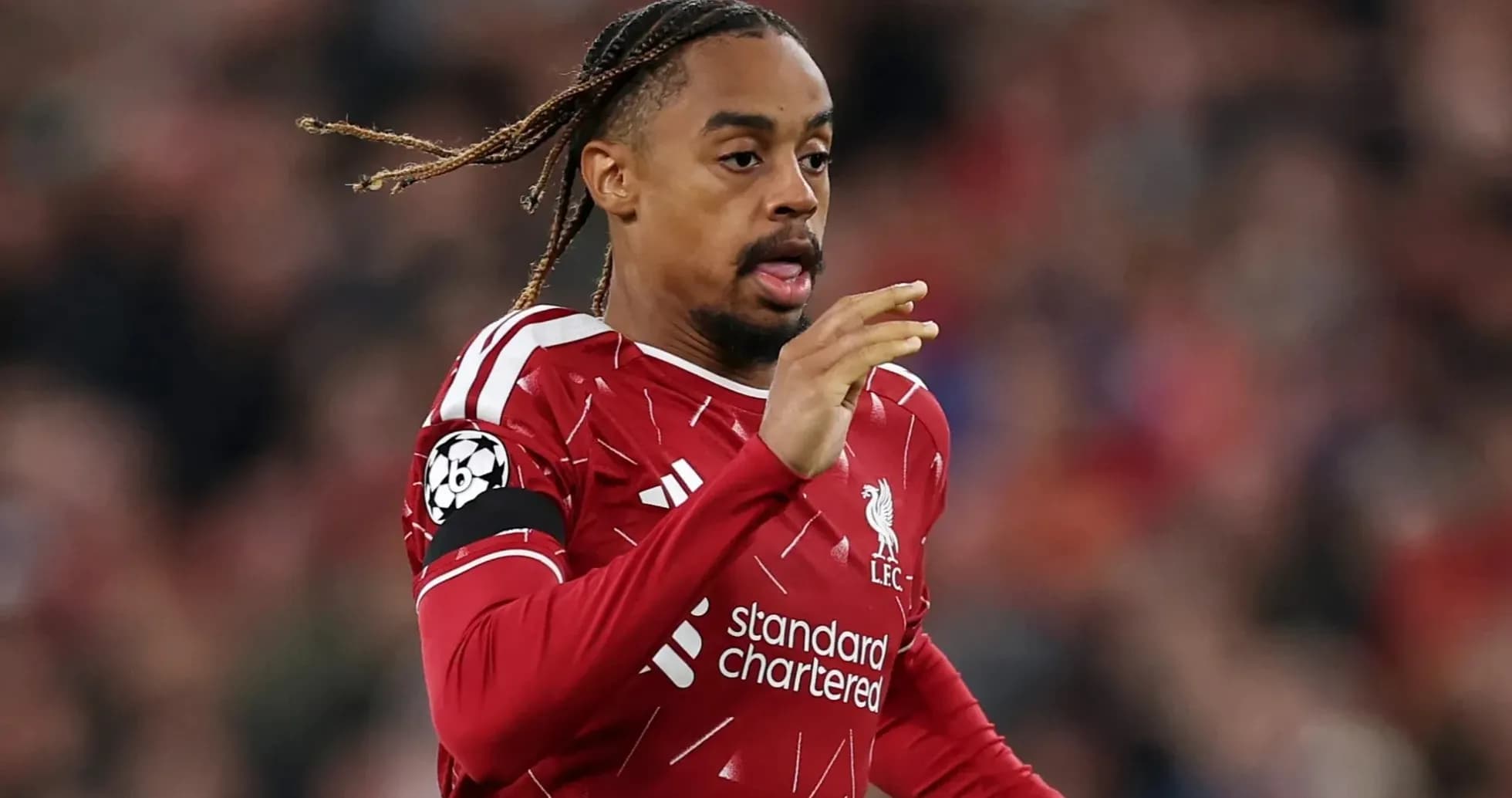 Player running during match wearing Liverpool jersey Player running during match wearing Liverpool jersey