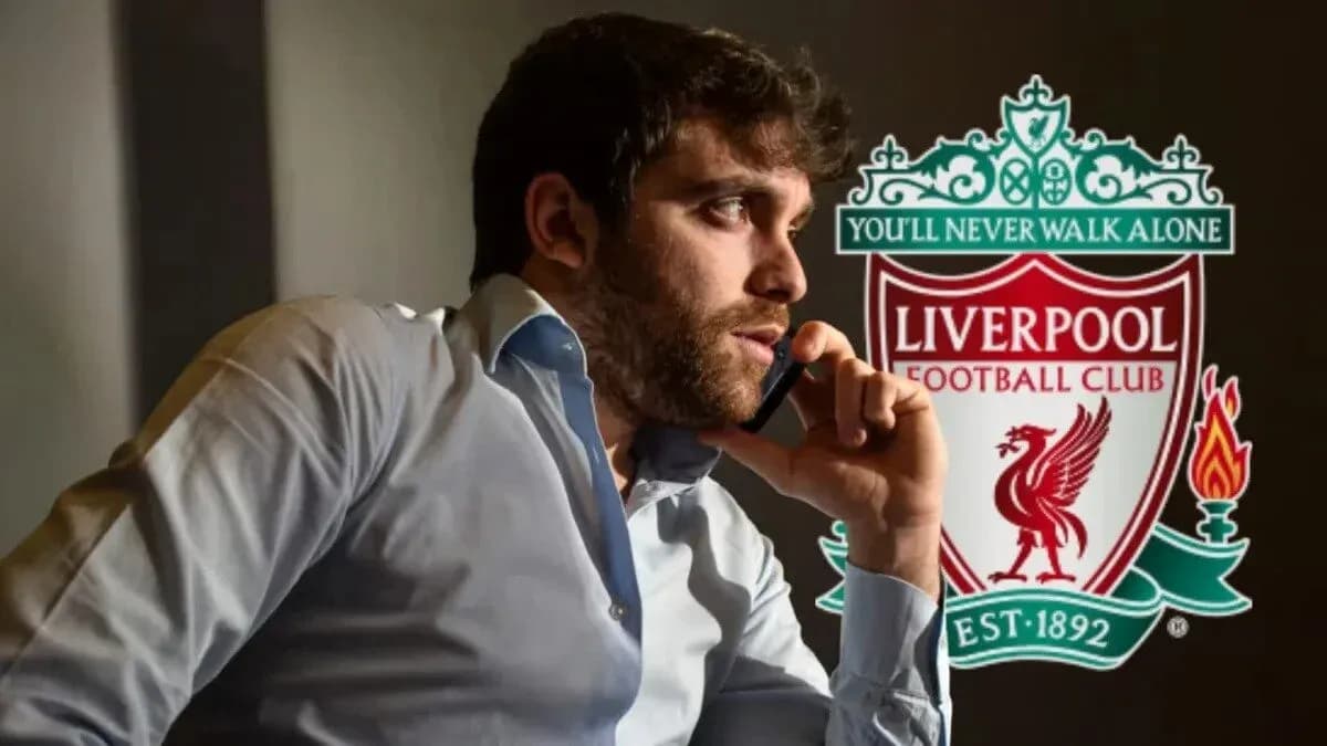 Man on phone with Liverpool FC logo in background Man on phone with Liverpool FC logo in background