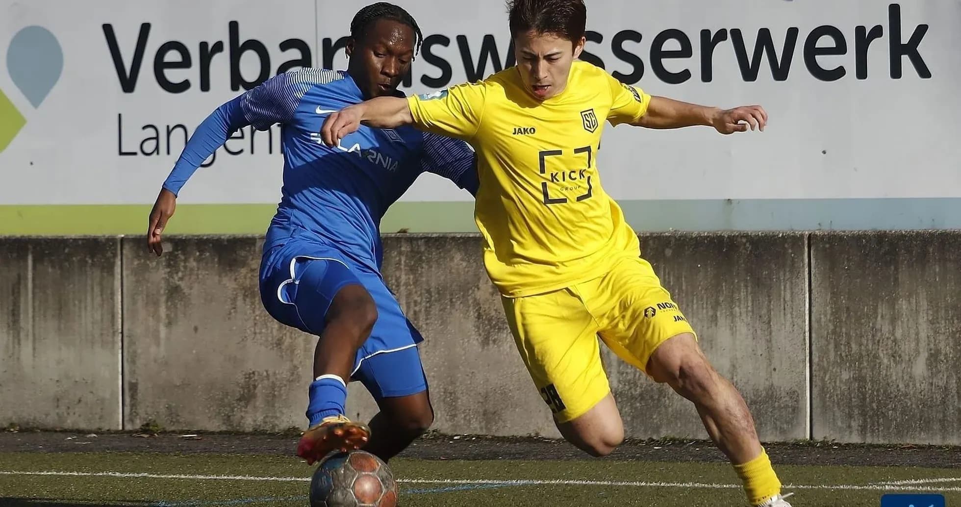 Two players competing for the ball in football match Two players competing for the ball in football match