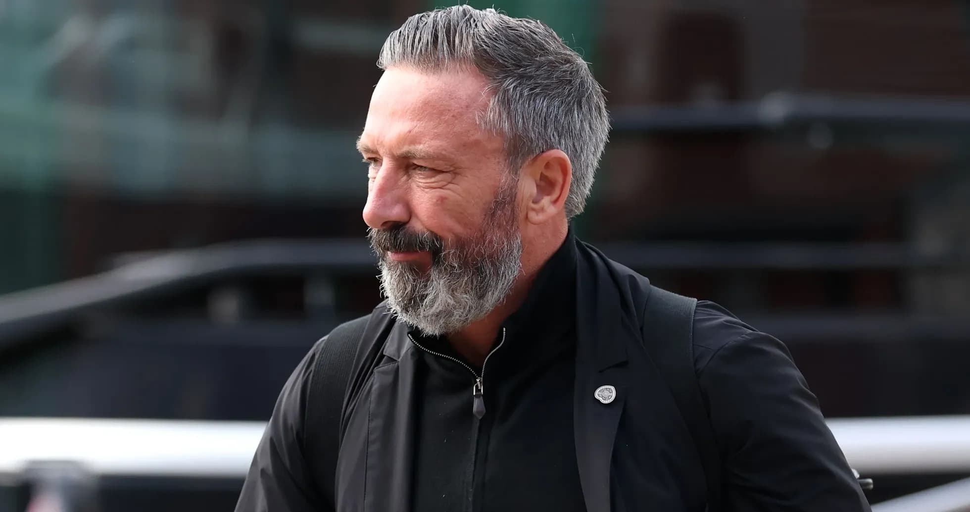 Man with grey beard walking outdoors Man with grey beard walking outdoors