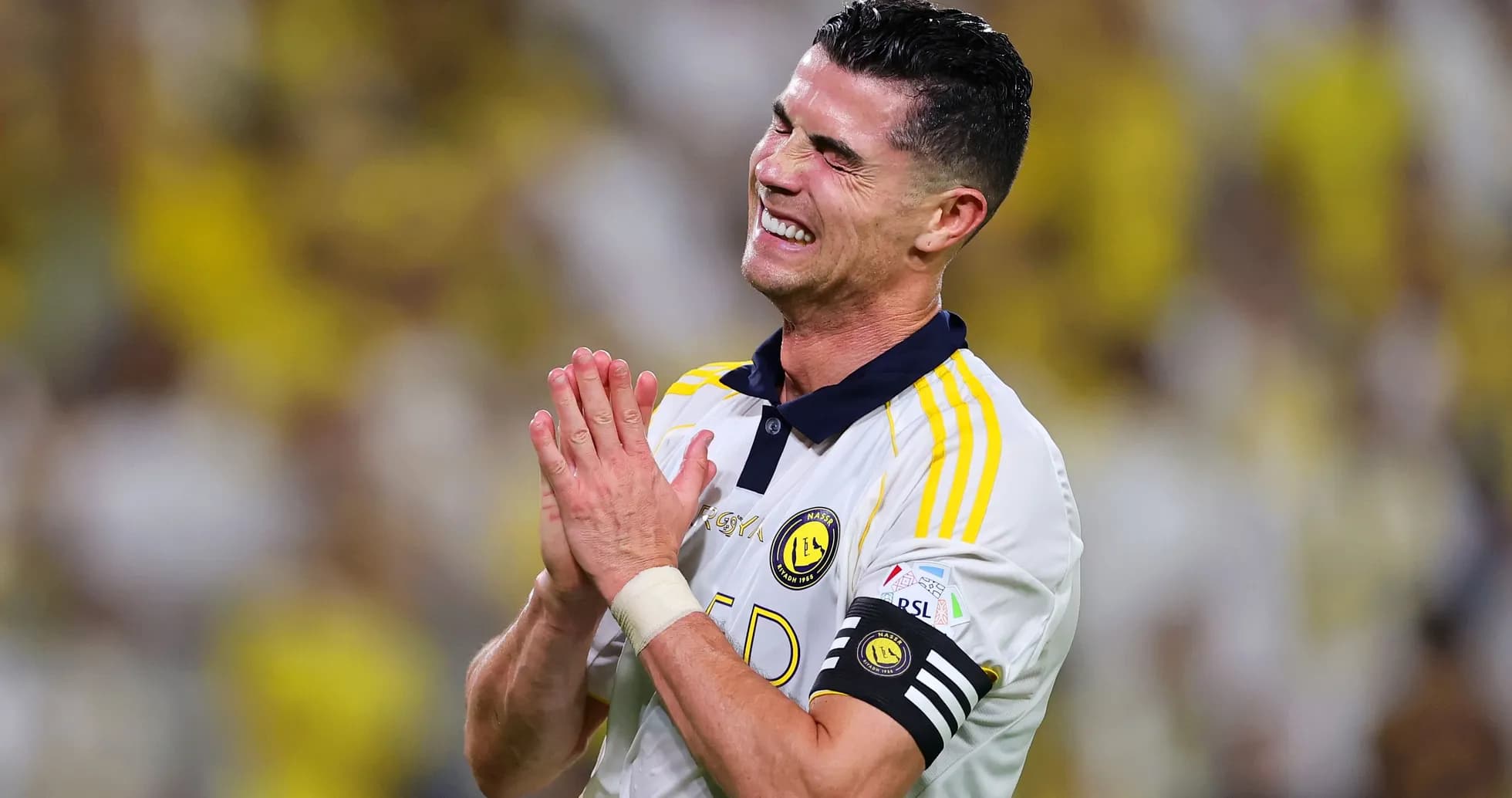Player celebrating with hands together on field Player celebrating with hands together on field