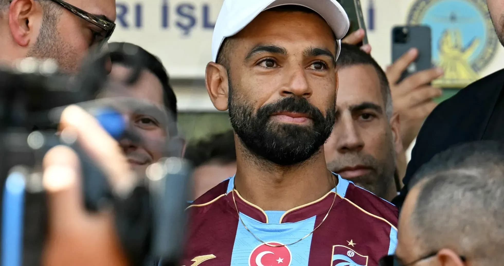 Player in Trabzonspor jersey surrounded by fans Player in Trabzonspor jersey surrounded by fans