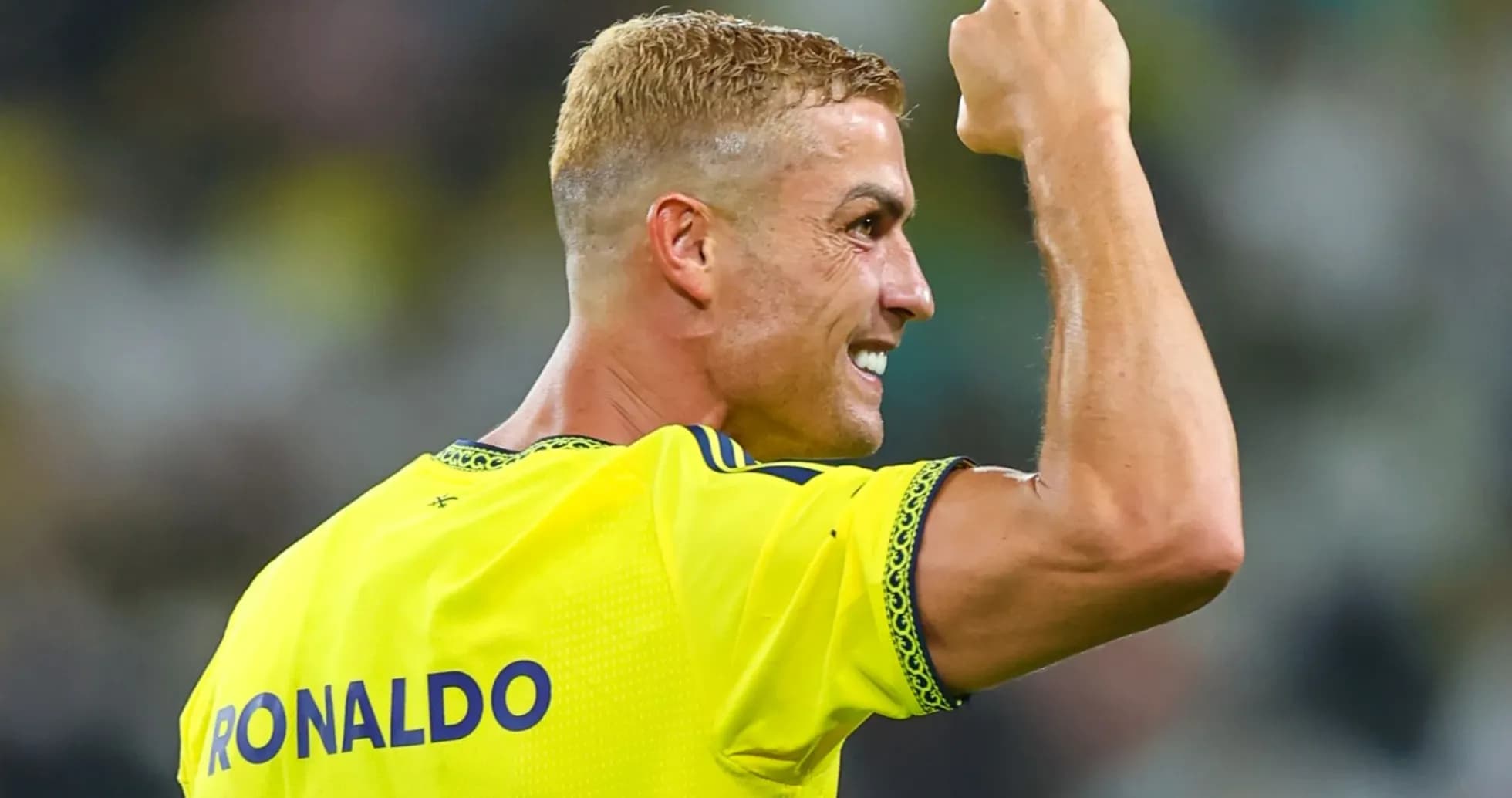 Player celebrating with raised fist in yellow jersey Player celebrating with raised fist in yellow jersey