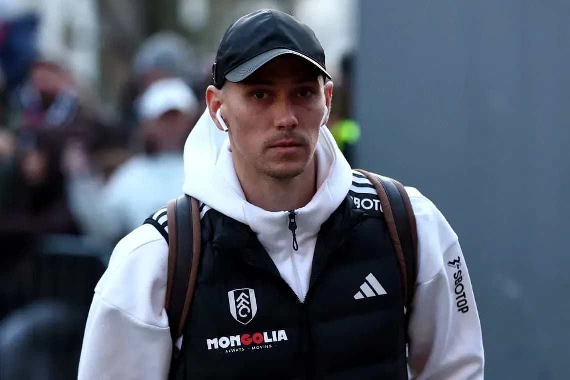 Player walking with earbuds and backpack before match Player walking with earbuds and backpack before match