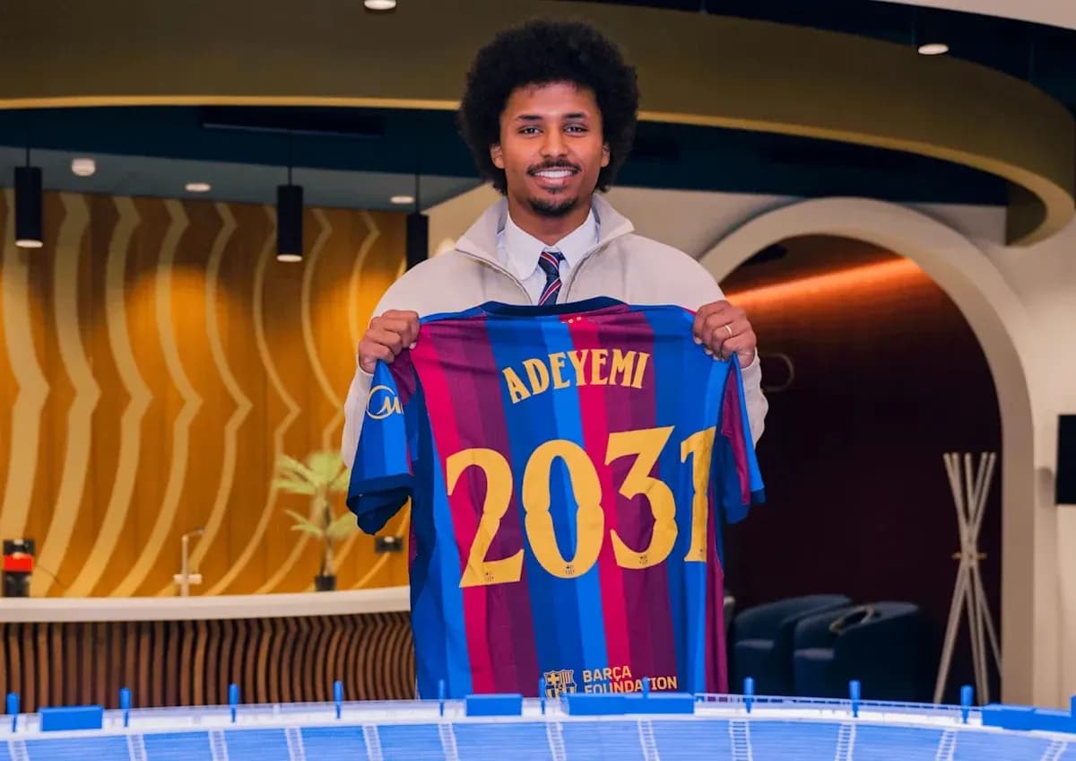 Player holding Barcelona jersey with Adeyemi and 2031 Player holding Barcelona jersey with Adeyemi and 2031
