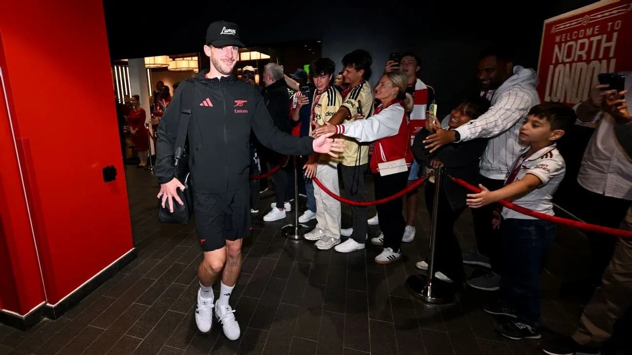 Player greeting fans while entering stadium lobby Player greeting fans while entering stadium lobby