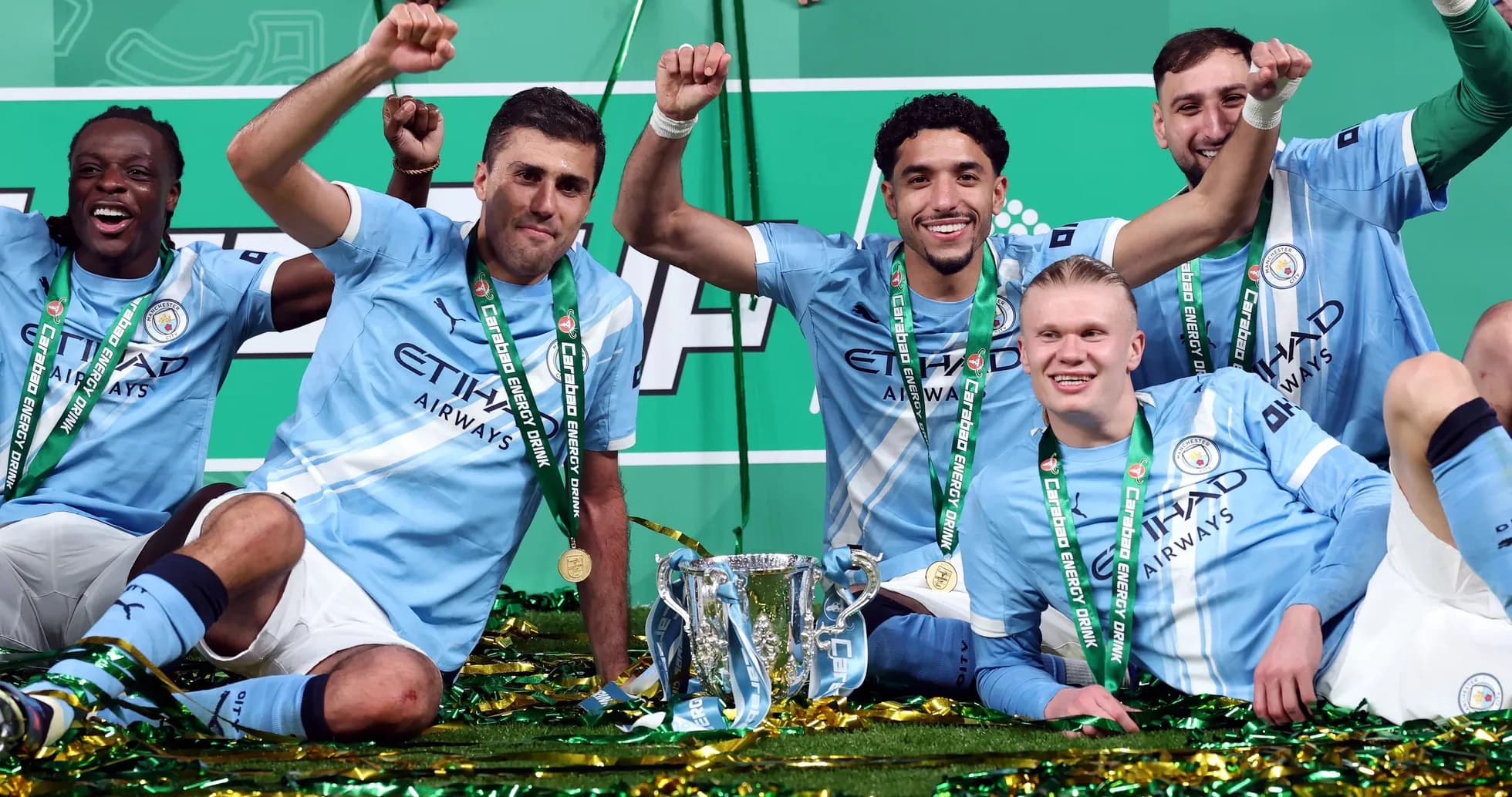 Manchester City players celebrating with trophy Manchester City players celebrating with trophy