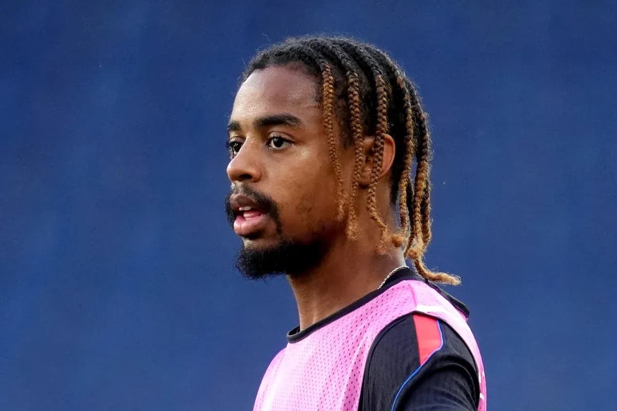 Player wearing a pink training vest on the field Player wearing a pink training vest on the field