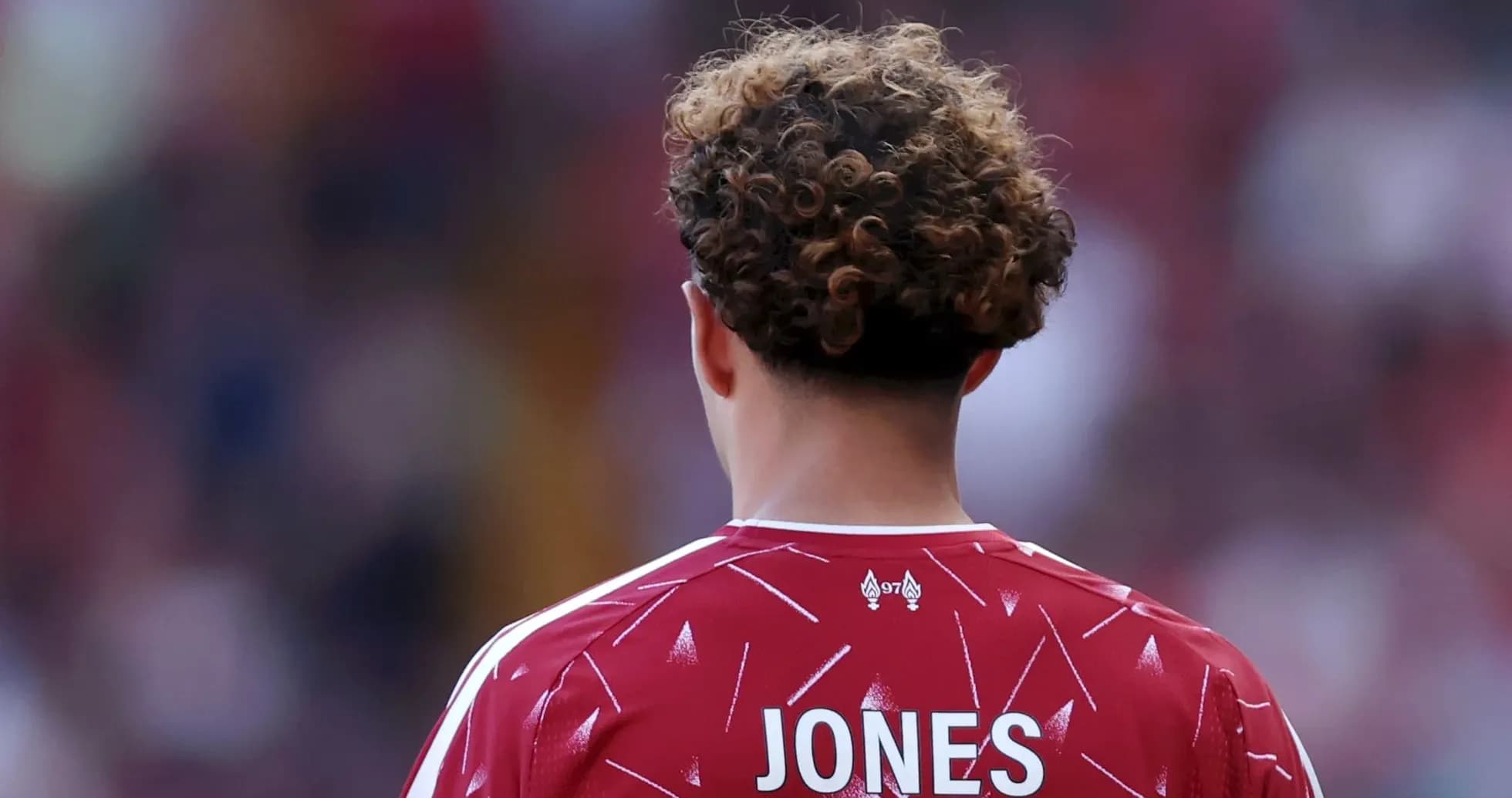 Player wearing red jersey with 'JONES' on back Player wearing red jersey with 'JONES' on back