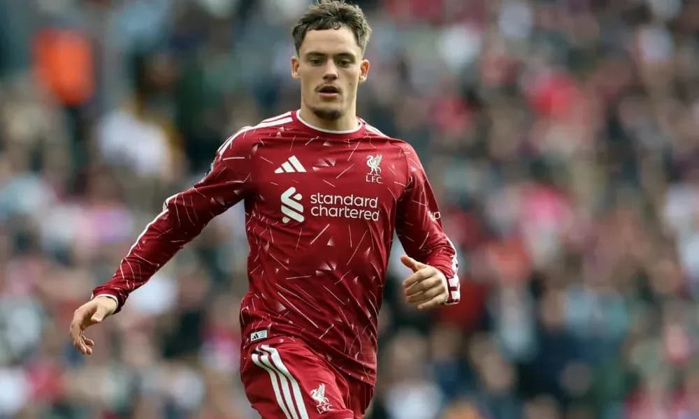 Player running in Liverpool FC kit during match Player running in Liverpool FC kit during match