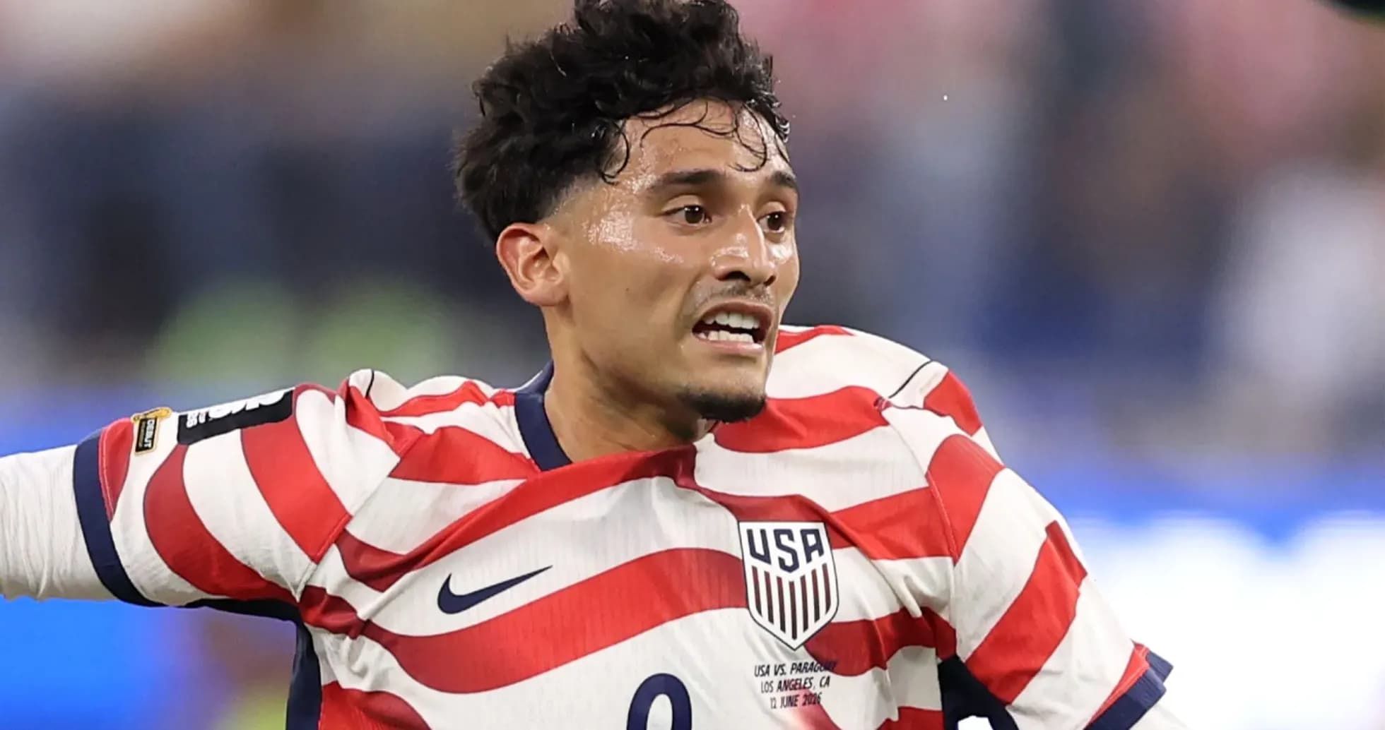 Player in red and white striped USA jersey during match Player in red and white striped USA jersey during match