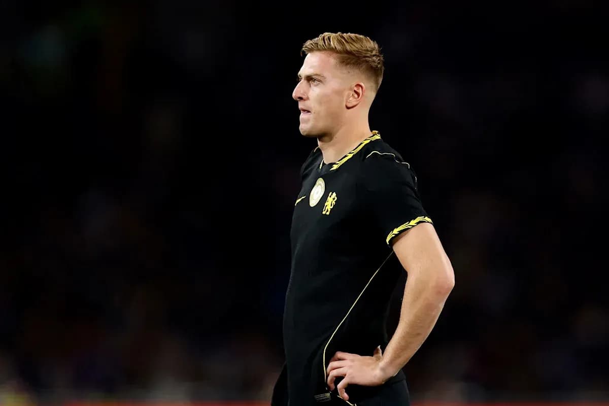 Player in black kit standing on the pitch Player in black kit standing on the pitch