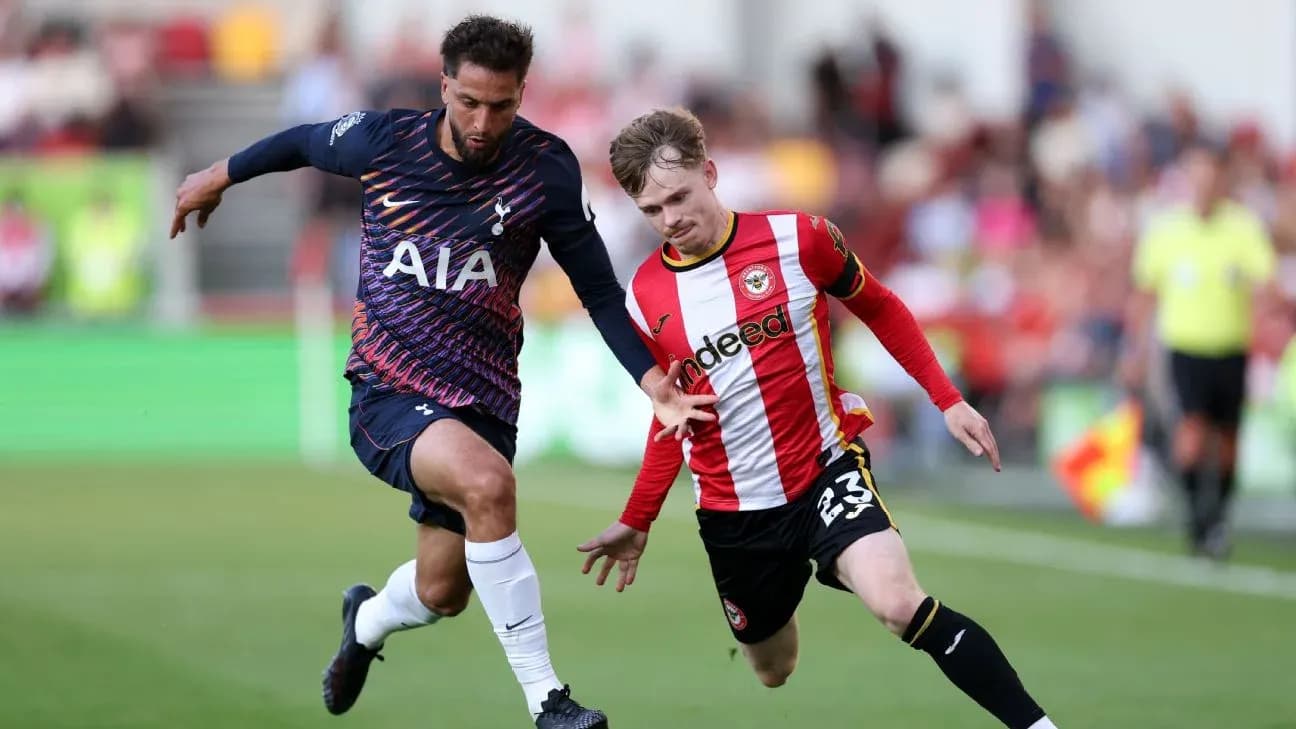 Brentford player challenging Tottenham opponent for ball Brentford player challenging Tottenham opponent for ball
