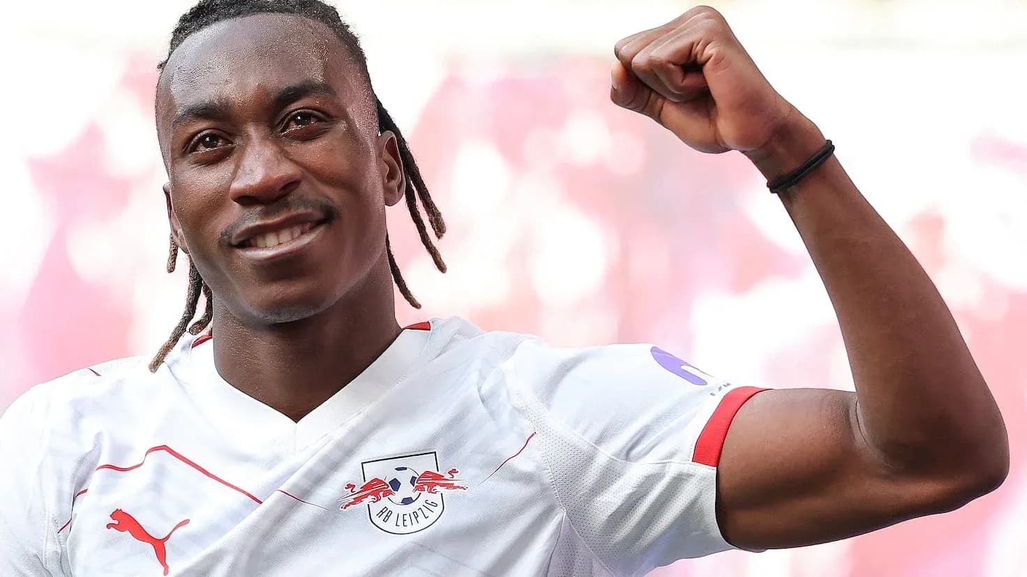 Player celebrating with raised fist in RB Leipzig jersey Player celebrating with raised fist in RB Leipzig jersey