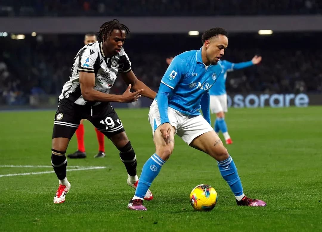 Player from Udinese challenges Napoli player for ball Player from Udinese challenges Napoli player for ball