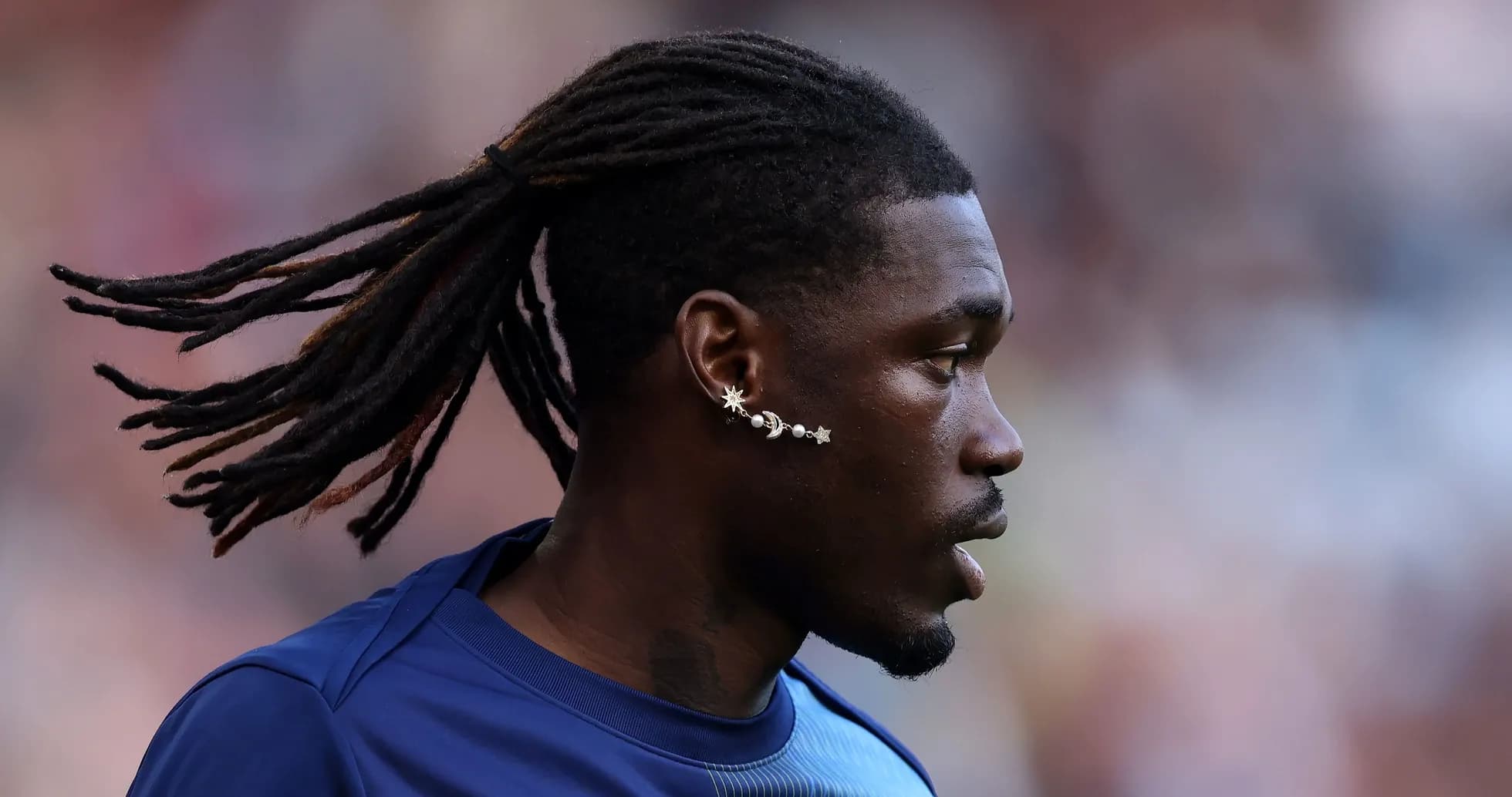 Player with dreadlocks and unique earrings in profile Player with dreadlocks and unique earrings in profile