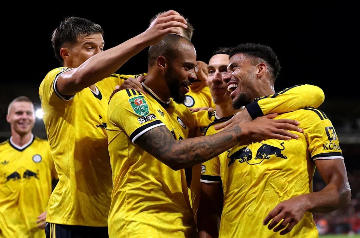 Players celebrating a goal in yellow jerseys Players celebrating a goal in yellow jerseys