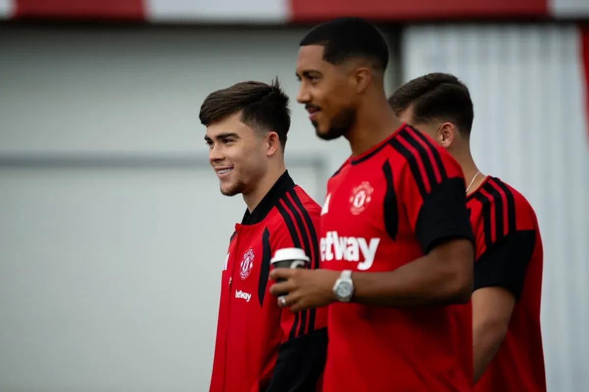 Players in Manchester United training kits smiling together Players in Manchester United training kits smiling together
