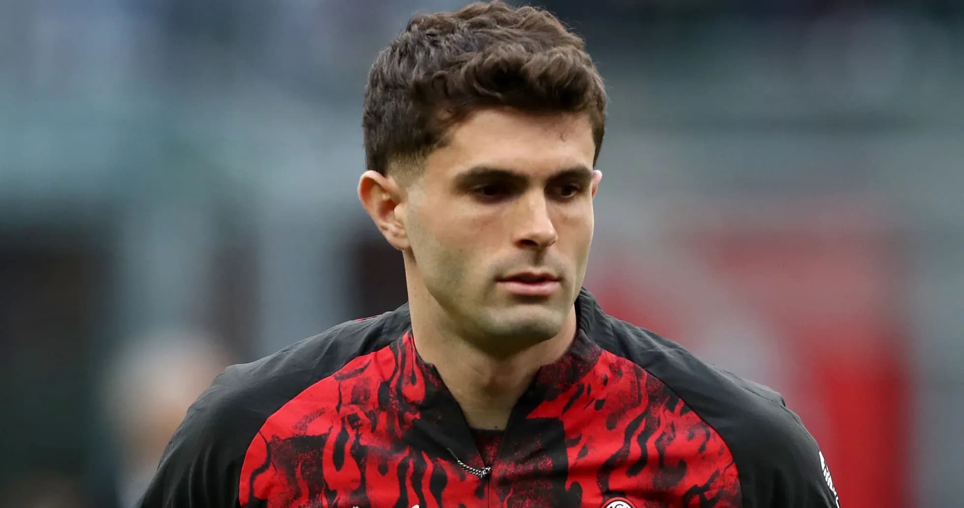 Player walking on the pitch in team uniform Player walking on the pitch in team uniform