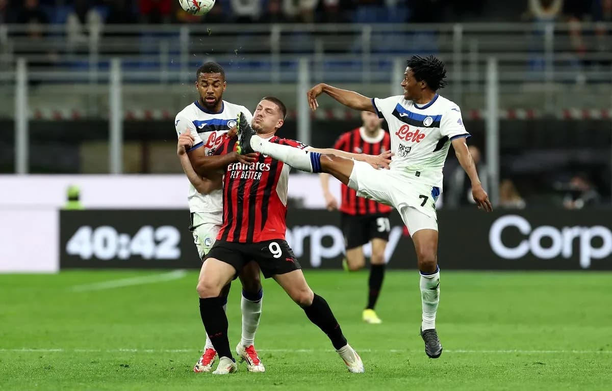 AC Milan player challenged by Atalanta defenders AC Milan player challenged by Atalanta defenders