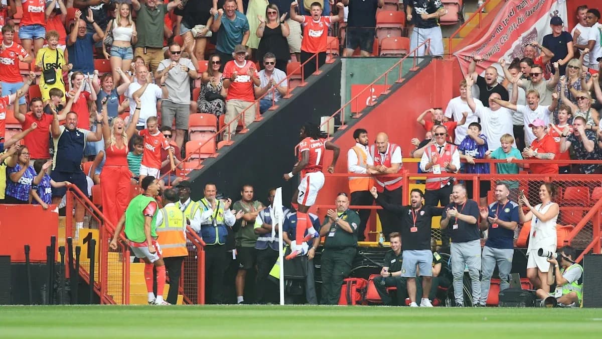 Player celebrating a goal with excited fans Player celebrating a goal with excited fans