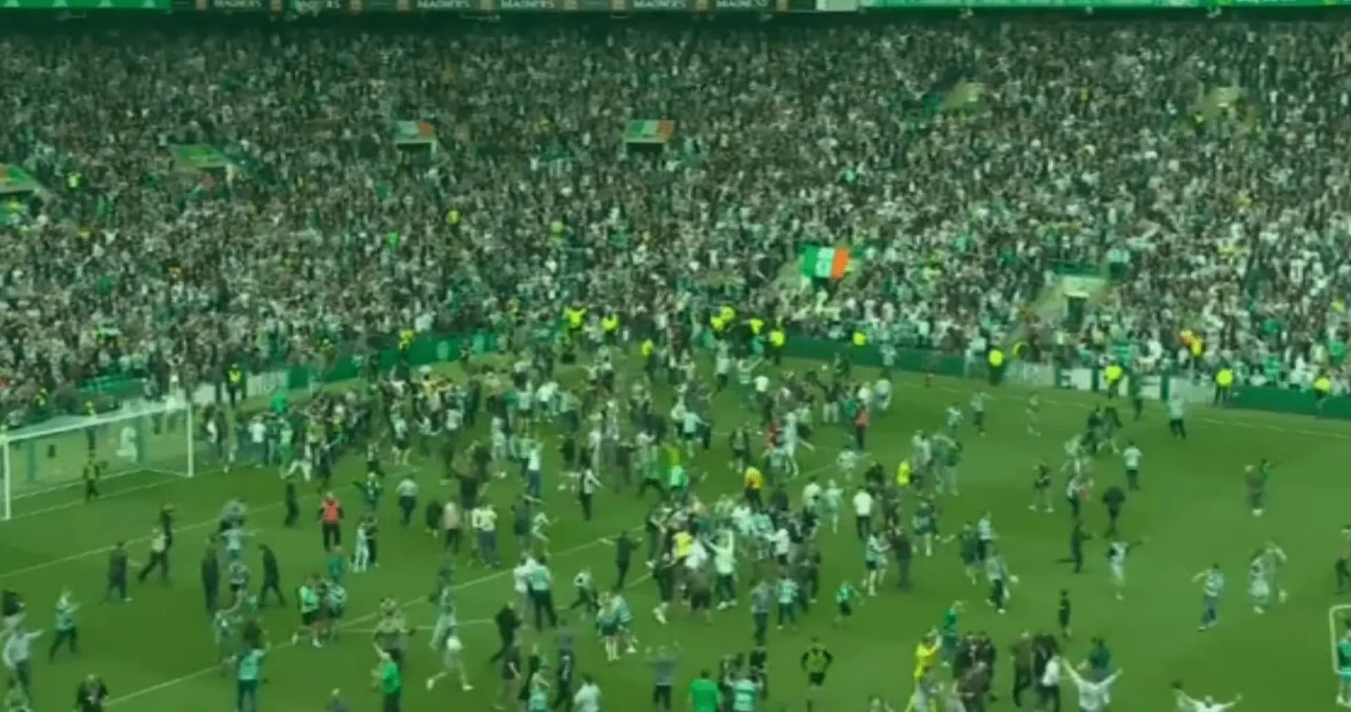 Fans celebrating on the pitch after the match Fans celebrating on the pitch after the match