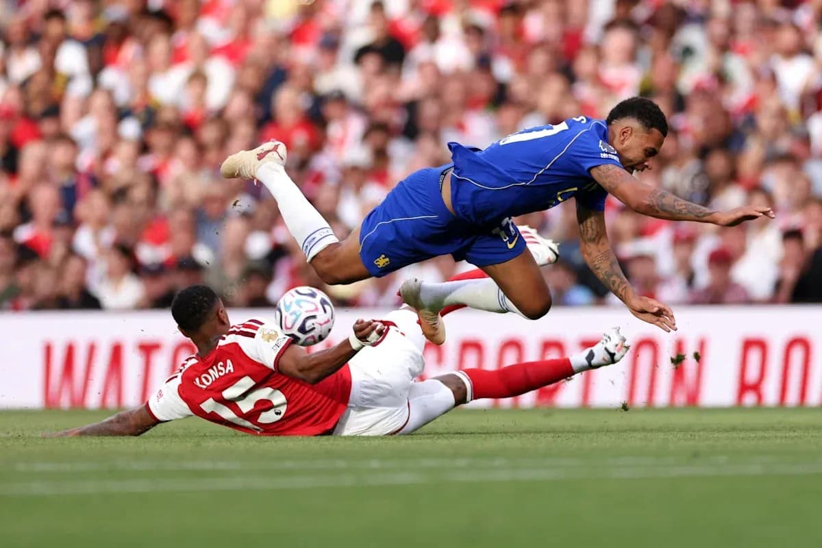 Player falling over another during football match Player falling over another during football match