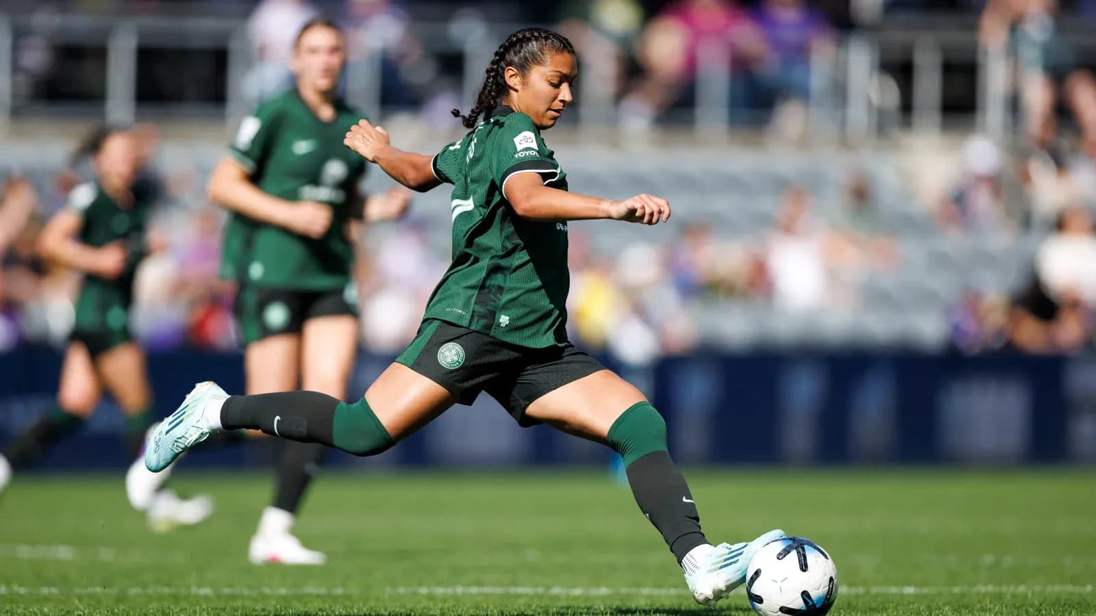 Player kicking the ball during NWSL match Player kicking the ball during NWSL match