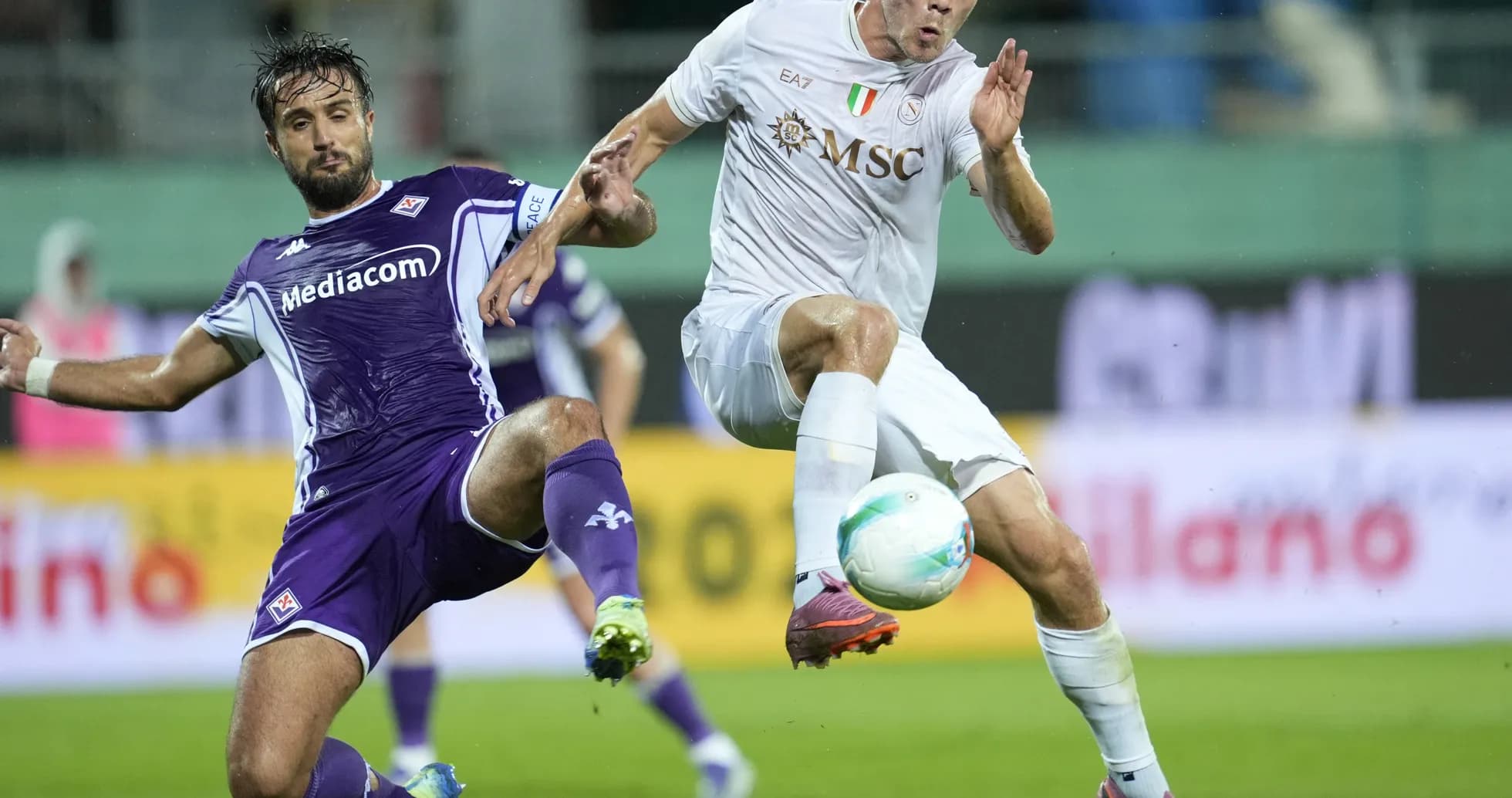 Fiorentina player challenges Napoli opponent for the ball Fiorentina player challenges Napoli opponent for the ball