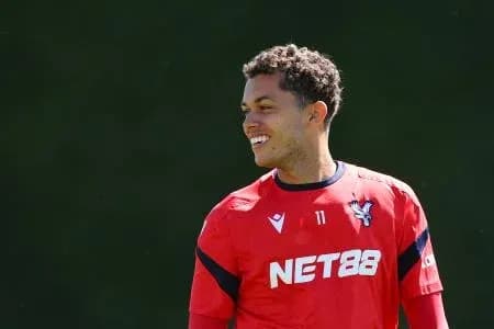 Player smiling during training session in red kit Player smiling during training session in red kit