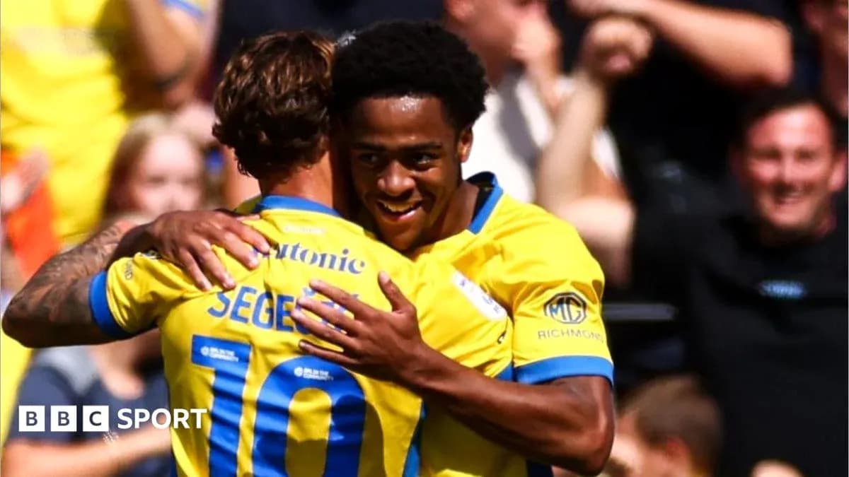 Players celebrating a goal with an embrace Players celebrating a goal with an embrace
