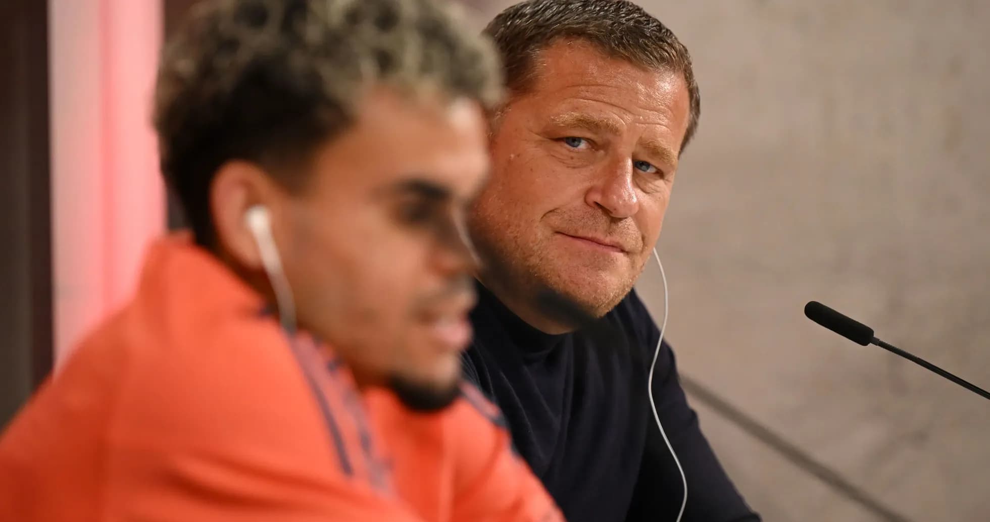 Two men at a press conference table Two men at a press conference table