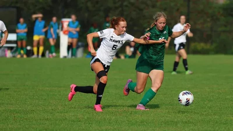 Two players competing for the ball during soccer match Two players competing for the ball during soccer match