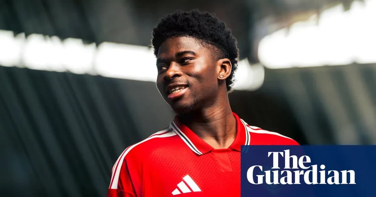 Player wearing red jersey smiling in studio Player wearing red jersey smiling in studio