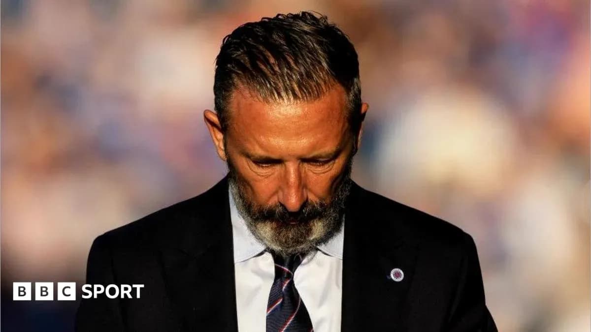 Man in suit looking down with serious expression Man in suit looking down with serious expression