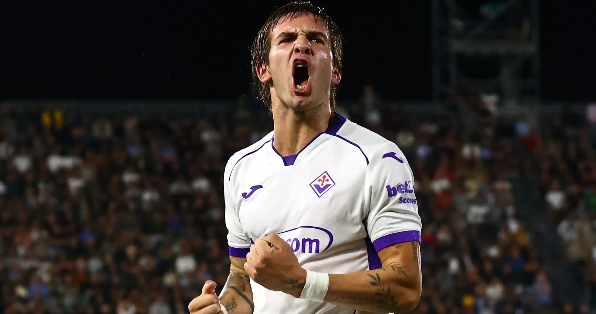 Player celebrating a goal in Fiorentina jersey Player celebrating a goal in Fiorentina jersey