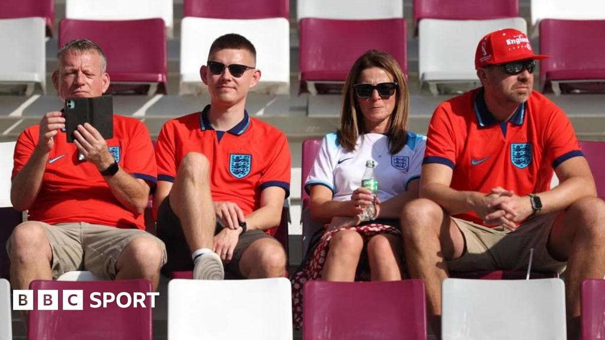 Four England fans sitting in stadium stands Four England fans sitting in stadium stands
