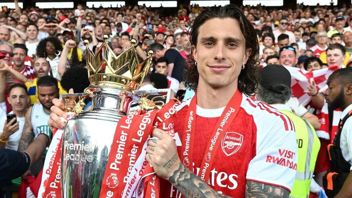 Player celebrating with Premier League trophy and fans Player celebrating with Premier League trophy and fans