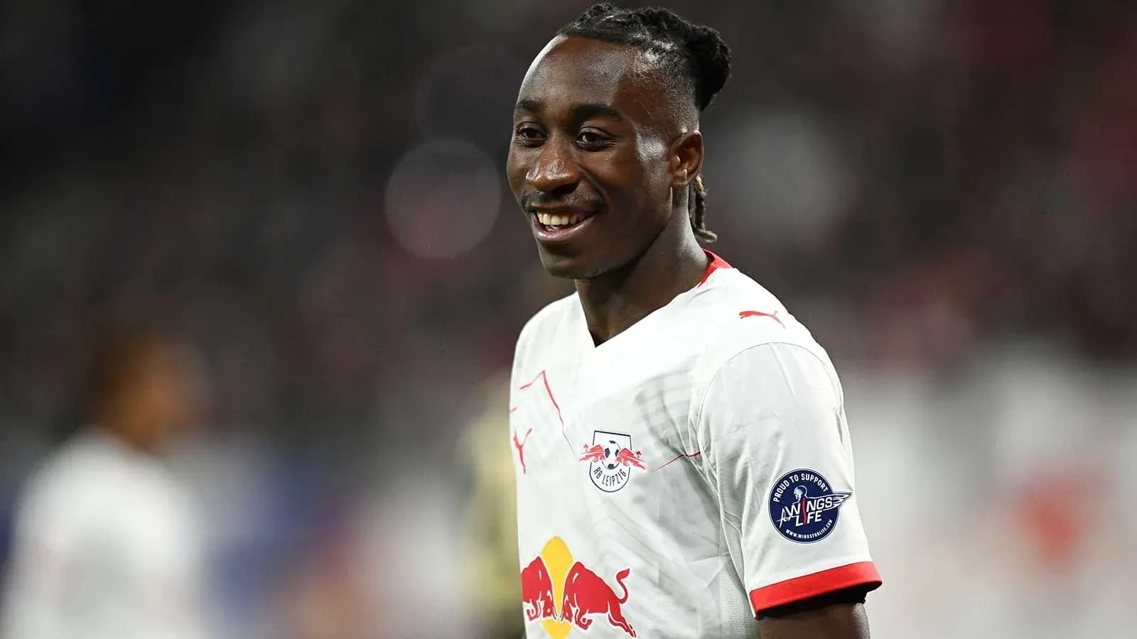 Player smiling in RB Leipzig jersey during match Player smiling in RB Leipzig jersey during match